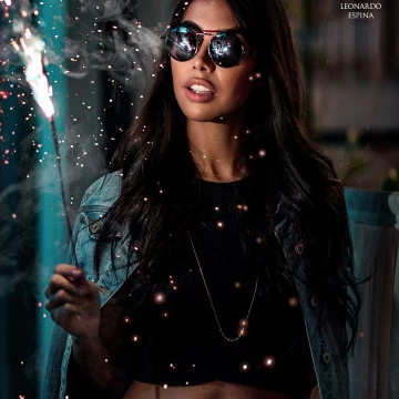 Playing with fire and sparkles. A night shot using high speed sync to freeze the fire in mid-air and using a speedlight flash to softly fill in the shadows.