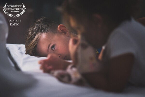 This picture is called "watching cartoons", because this snapshoot has been made during Kids are watching cartoons on a smatphone. The perfect light on the boys face was from the smartphone and I think that the Pic is very cute. I love it.