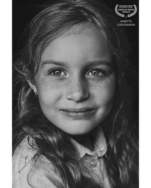 This is Liv, a very sweet girl with beautiful light eyes and freckles. a combination I love with portrait shoots. The black and white editing makes this photo so pure.
