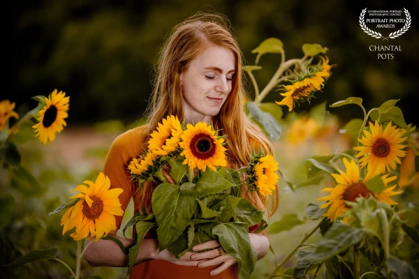 'Among fields of gold, she closes her eyes and listens to the whispers of the sunflowers — a quiet m...