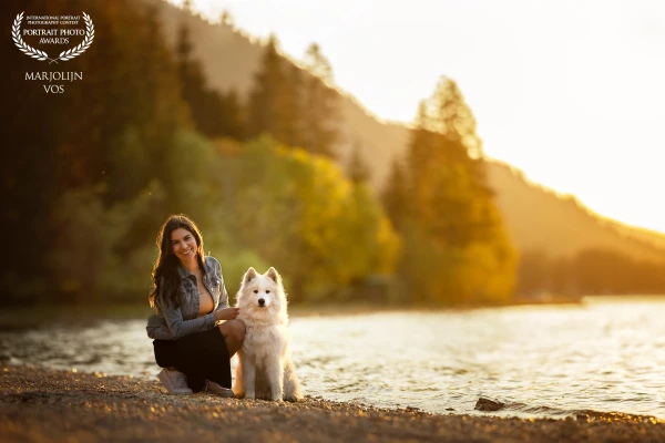 By the serene shores of the Haldensee, the woman and her dog stand side by side, eyes aligned, heart...
