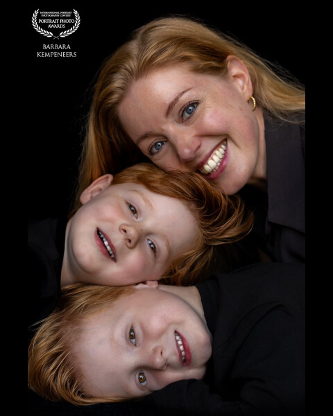 A bit unusual portrait of a mother with her two sons. Just the way they are. A bit of fun, a bit of...