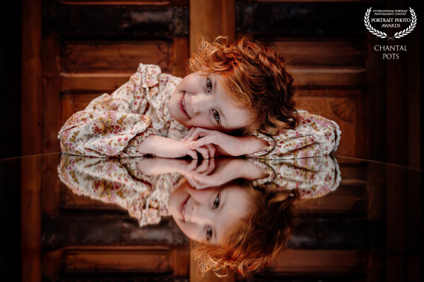There’s something timeless about a quiet moment like this.
Soft freckles, wild red curls, and a refl...