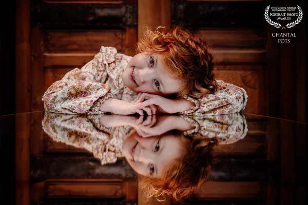 There’s something timeless about a quiet moment like this.
Soft freckles, wild red curls, and a refl...