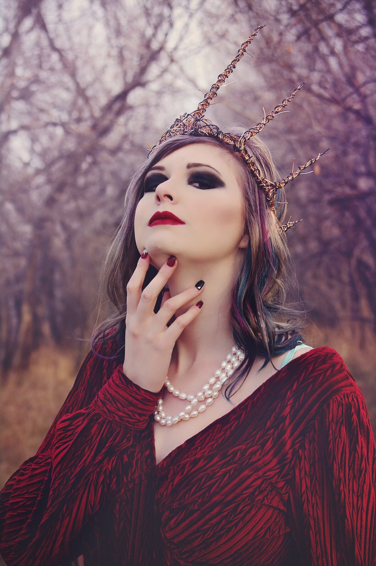 This photo was taken on a very cold day in Saskatoon, SK. There is a beautiful grove of trees that looks as though it's straight from a storybook; it was the perfect location for an 'Evil Queen' photo shoot. The crown was handmade using multiple lengths of 16g wire. <br />
Model: Julia Kurylyk from Infinity Models Saskatoon<br />
Hair and Makeup Artist: Kiana Johnstone<br />
Photography and Styling: Amanda Adam<br />
Crown: Jon Hardybala