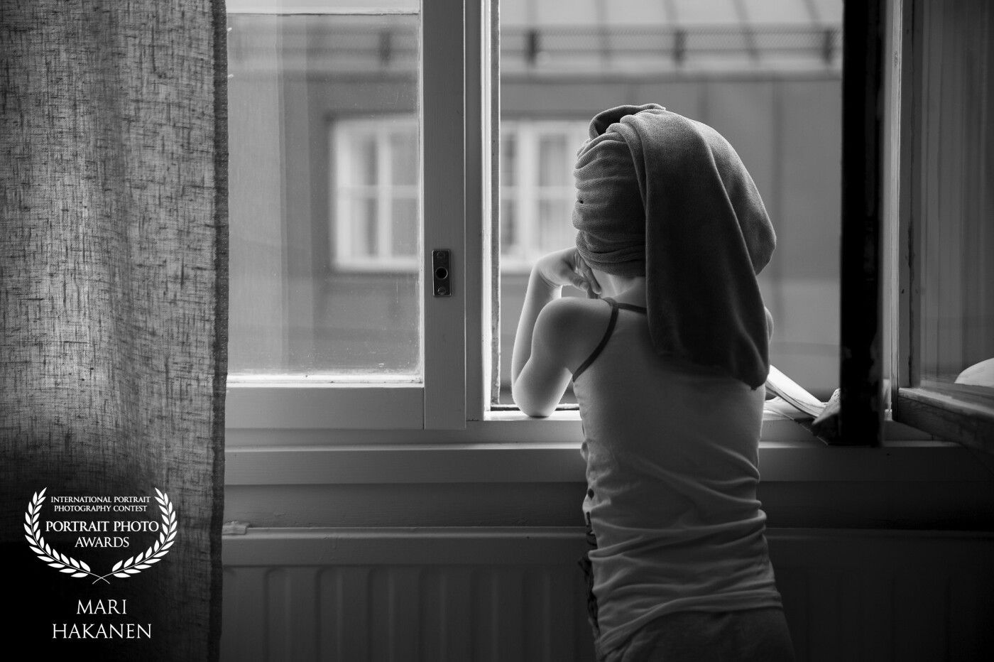 This is a photo of my daughter and it was taken one morning when she had gotten out of the shower and stopped at the window to watch the people walking  below.<br />
