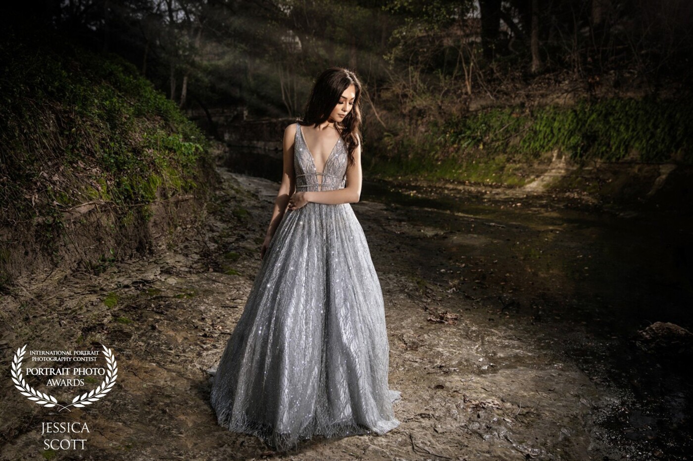 This portrait of Maddie was taken in an old creek in Dallas, Texas. This beautiful prom dress took this session to a whole other level. <br />
<br />
Shot with a Canon Mark IV and a 24-70mm L 2.8 lens. I had a wireless Godox strobe off to the right side and another Godox strobe highlighting her hair. The background was lit up with 2 Canon 600EX RT flashes. 