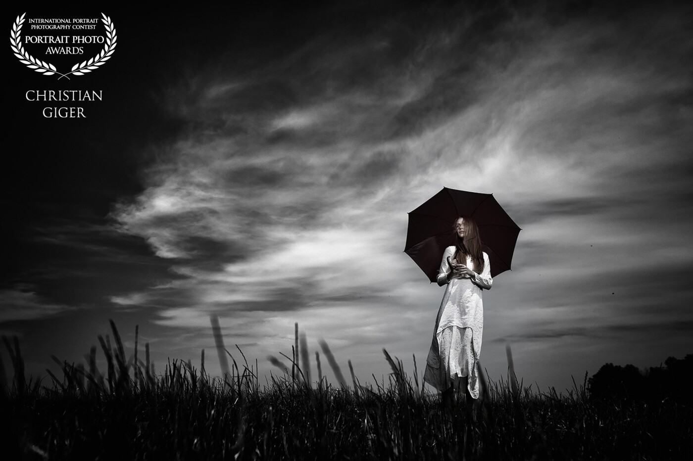 "Wandering under the sky". I used a portable flash system with an 18cm reflector with a grid to lighten the model's face as much as possible. The flash was being placed about 5m away from the model - just outside the picture.<br />
M: Lena