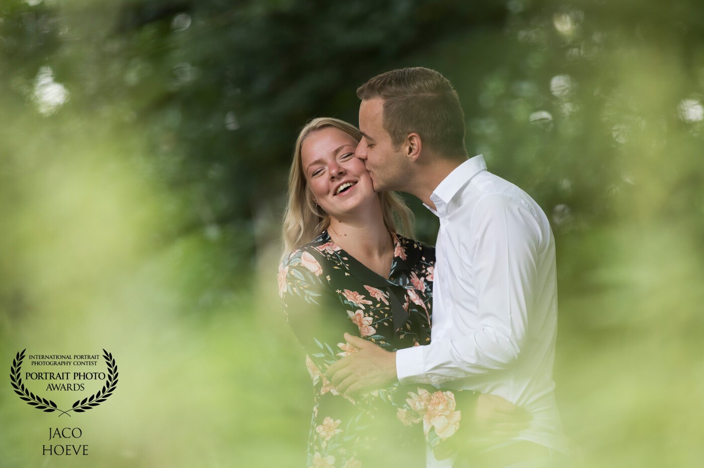 Just a love shoot during a family report! She reacts so spontaneously when her boyfriend gives her a kiss between the nice green shrubs.