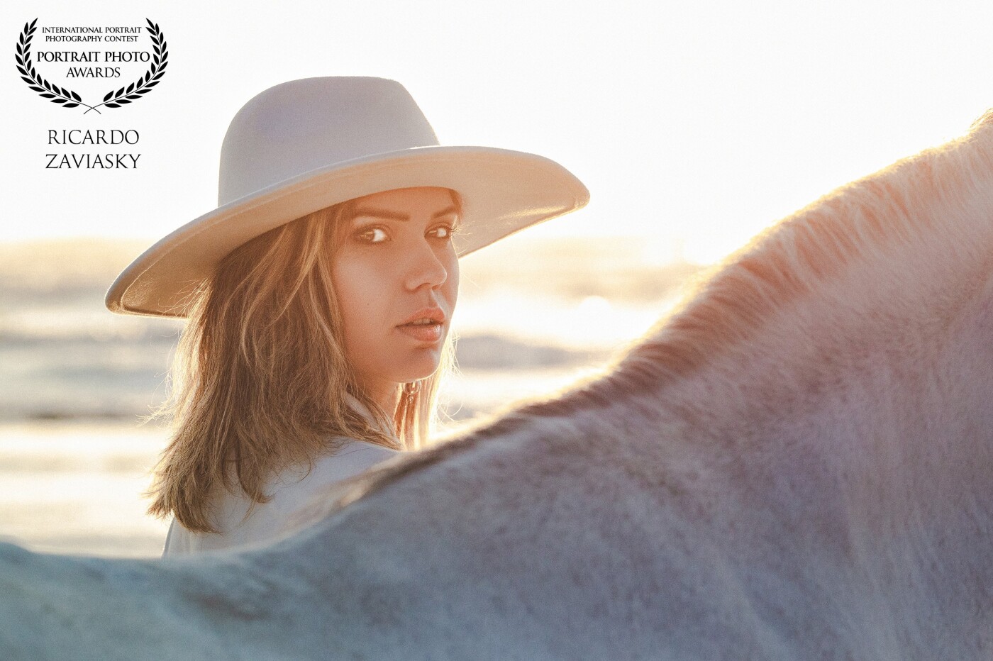 This photo was taken in the first rays of the Sun on an almost deserted beach, taking advantage of the sunlight to compose the scene between the model and the horse. Special thanks to model Ketherin for believing in our work and to Haras São Francisco, who provided us with such wonderful horses.