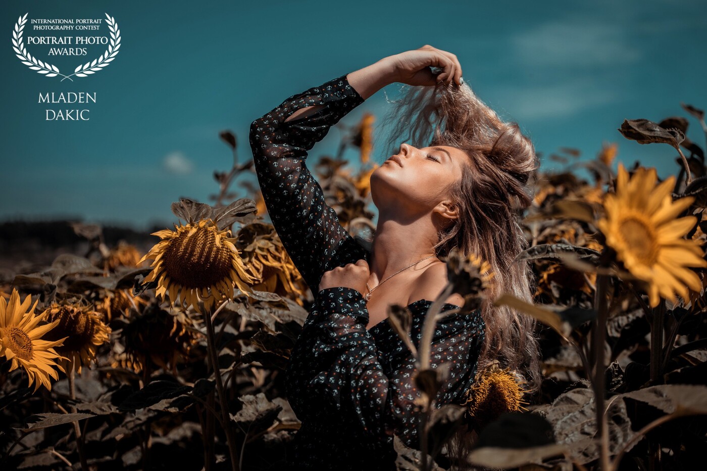 This picture is one of several photos of my model Jana in a sunflower field. That's why I named it "between the Sunflowers". I like this picture very much, it's absolutely stunning and an advertisement for summer time.<br />
<br />
I used natural light only.