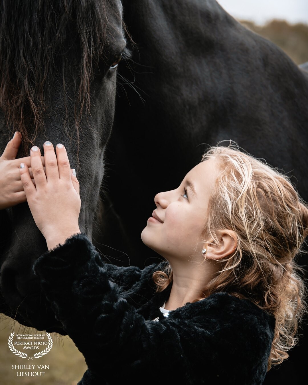 My daughter Fleur meeting big Friesian Anna for the first time. Fleur first impressed by the size and greatness of Anna but soon she dared to cuddle and stand next to her so this beautiful picture could be made.