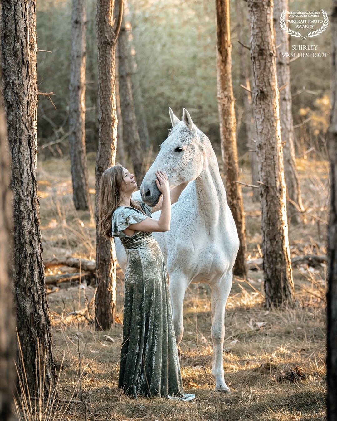 In this picture lovely Sharon with her sweet and well-behaved horse Cumlaude. Although this photo was taken at the end of February it looks like a Summer picture to me. The beautiful green, velvet dress and the location in the woods gives this photo a bit of a fairytale touch.