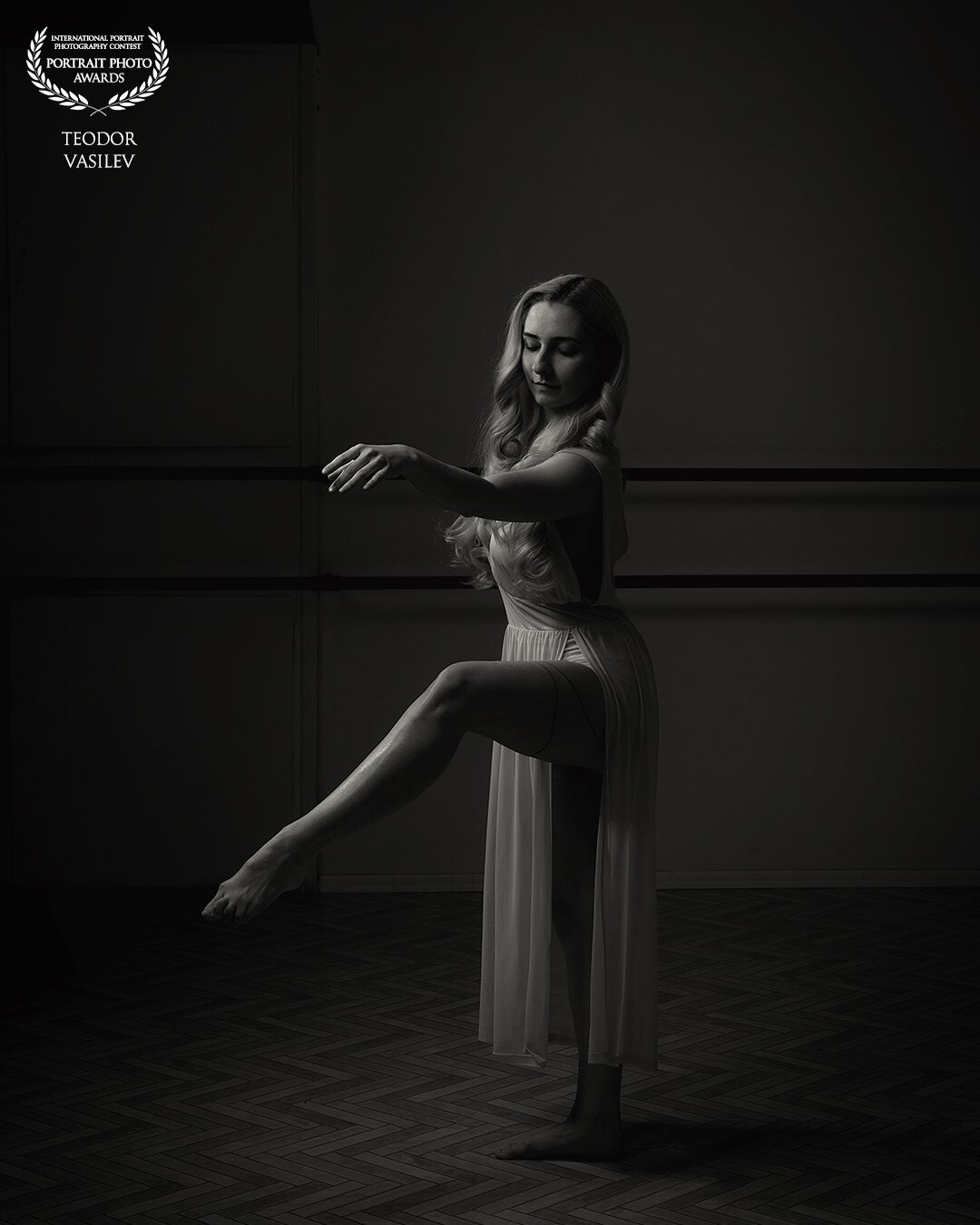 Lora is a former ballet dancer. However ballet will always be a passion. The photo was taken in a ballet dance room with one light only.