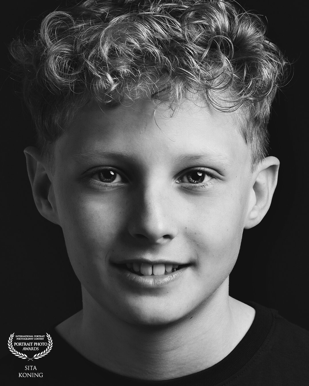 Just this happy face, strong portret of a young man. The curls and pretty eyes make this picture perfect I think. The combination with black and white version