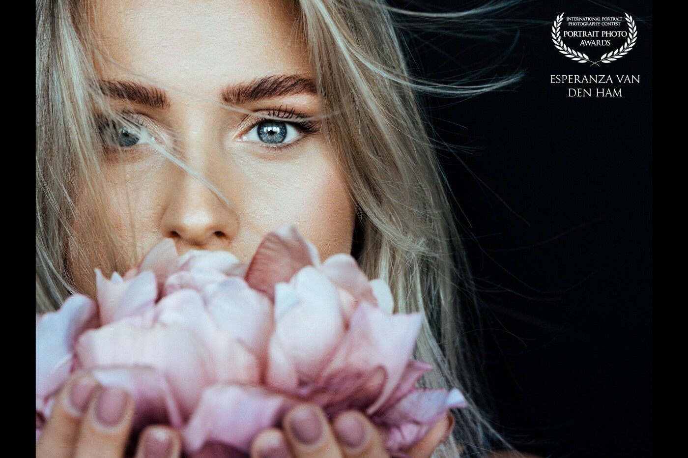 Wind and flowers and focus on the eyes made this photo so magical! <br />
<br />
Model: Eva<br />
Created by: @iamshootingportraits<br />
www.iamshootingportraits.nl