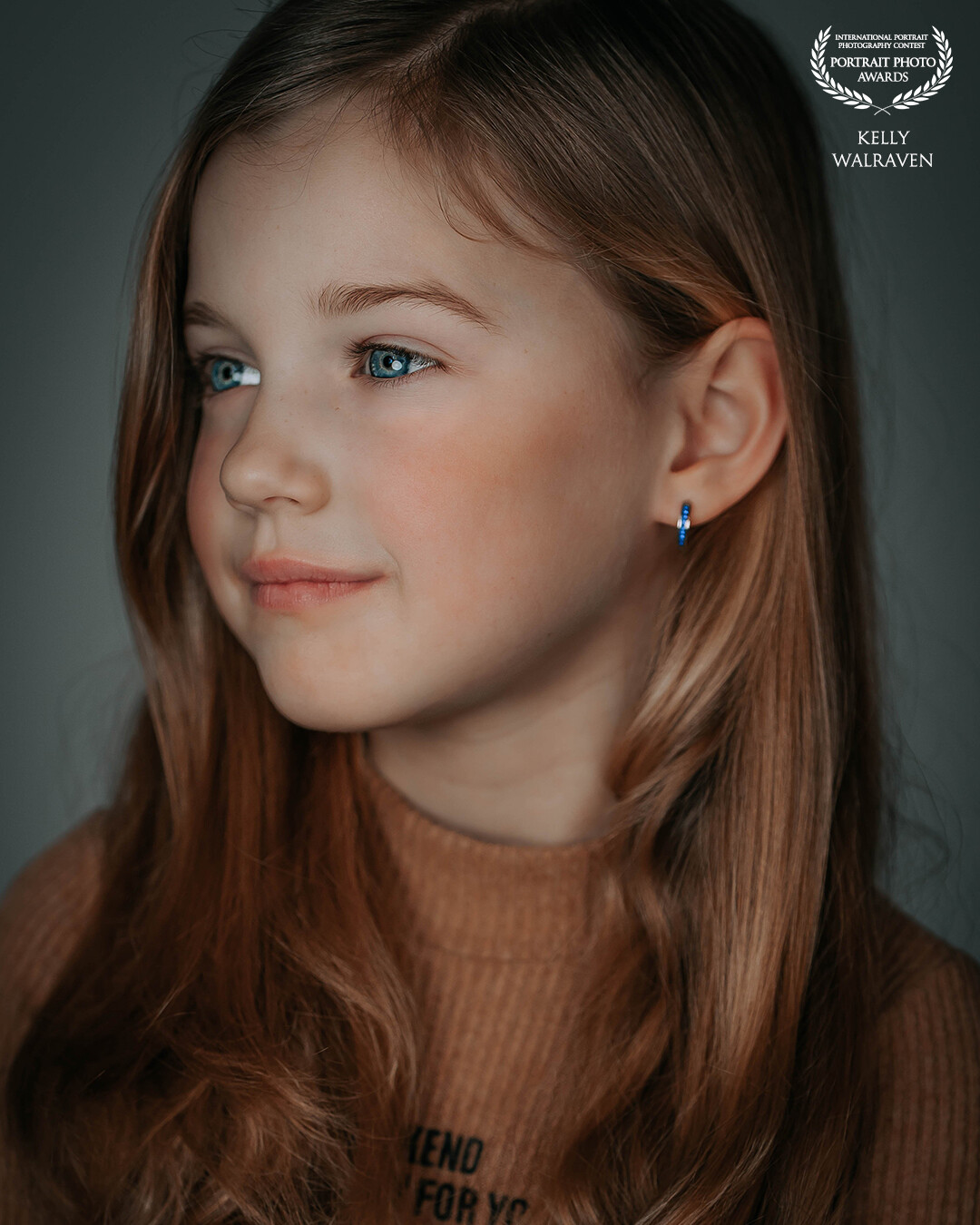 So young and yet so mature in the way she looks! A cute & powerful little girl with her beautiful blue eyes and warm hair!