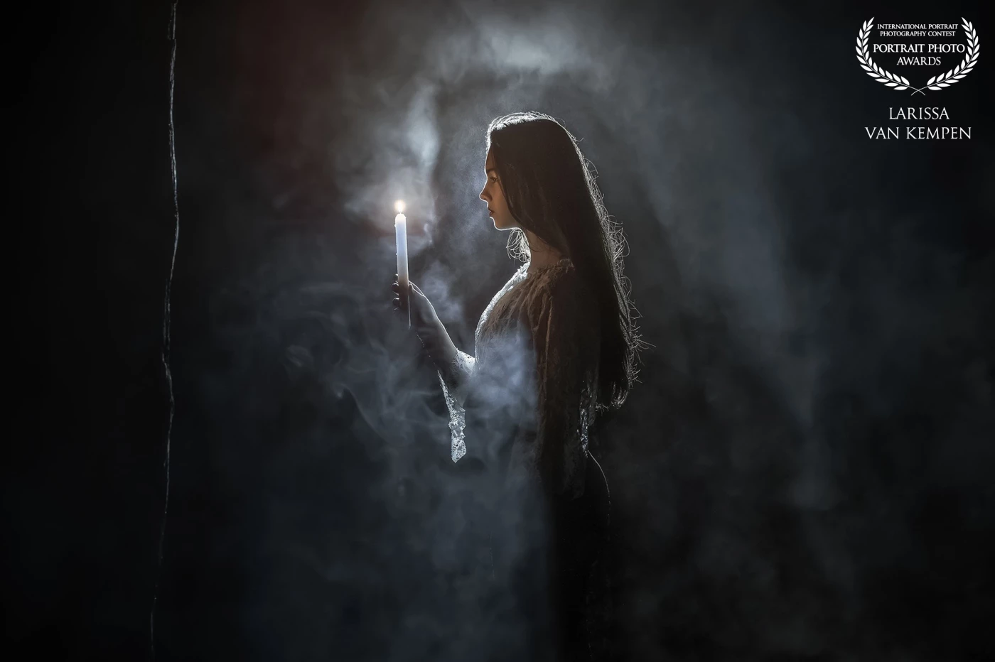 "Darkness admires the light; light admires what it illuminates."<br />
<br />
In this portrait, shadow and light engage in quiet dialogue. A lone figure, draped in timeless lace, holds a candle — not to chase the dark away, but to meet it with presence.<br />
<br />
This image evokes the eternal balance between vulnerability and strength, between what is hidden and what dares to be seen.<br />
She does not fear the night — she listens to it.<br />
<br />
A Legacy Portrait that captures more than a moment: it becomes a mirror of the soul.