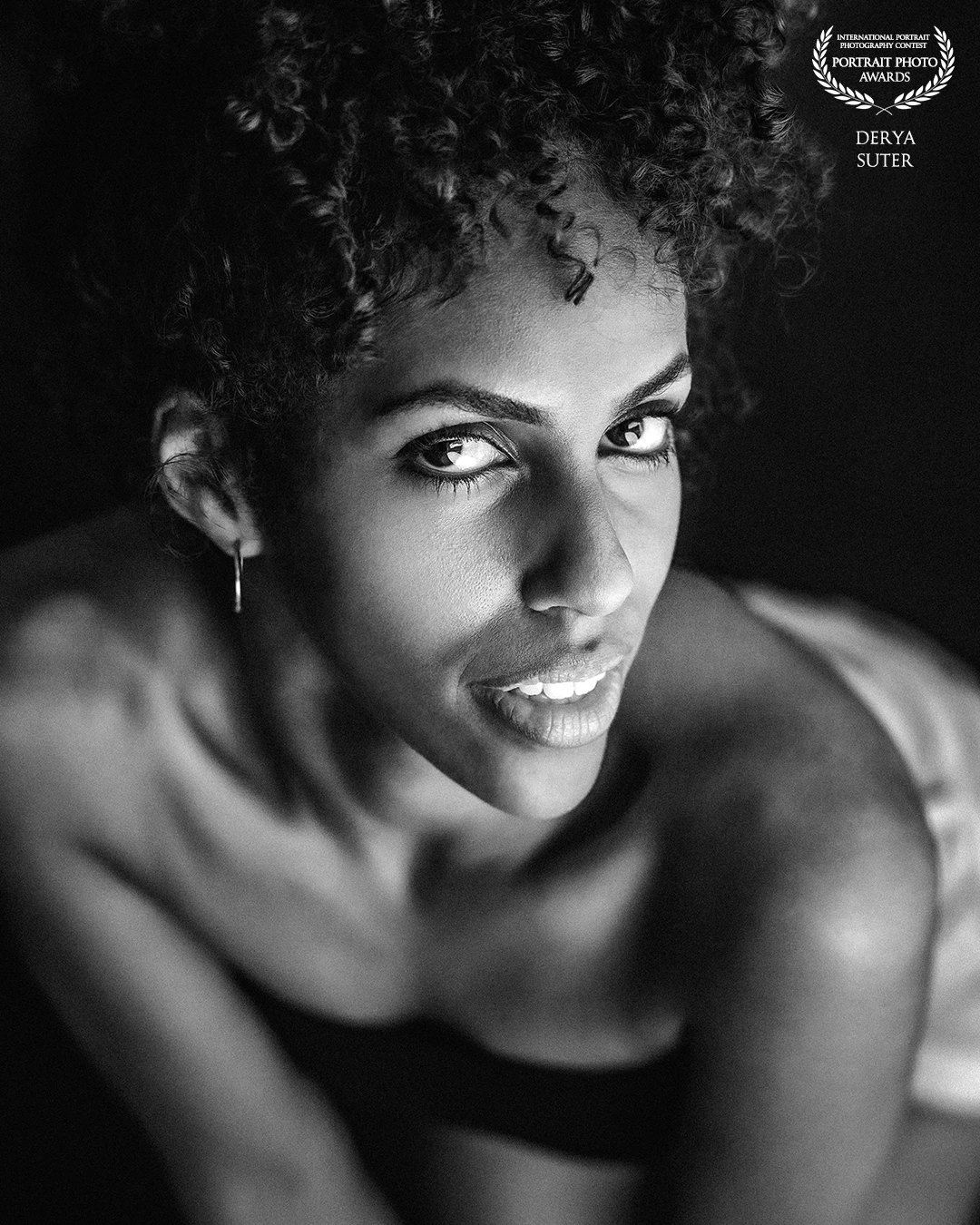 The Portrait Photo Awards is delighted to honor Derya Suter among this year’s distinguished honorees. His intimate black-and-white portrait—defined by its velvety tonal range, impeccable focus on the subject’s luminous gaze, and graceful composition—garnered special praise from our international jury for its authentic emotional depth. Congratulations to Derya and to all exceptional finalists.