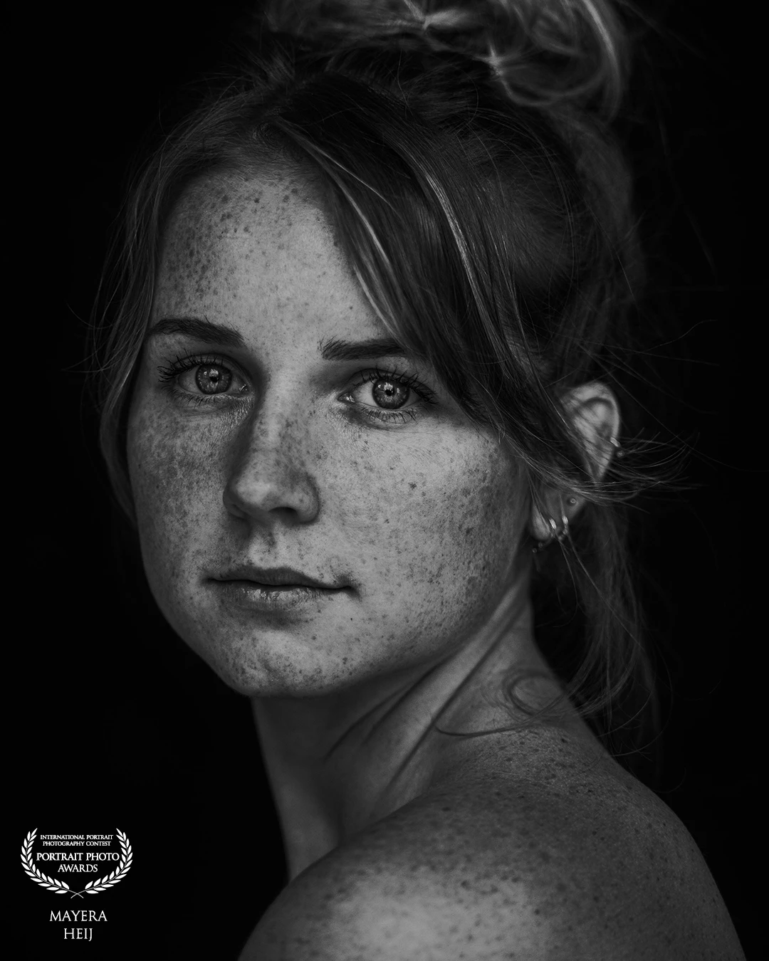 A daylight portrait of this lovely lady. Her freckles stand out well with the contrast in the photo.