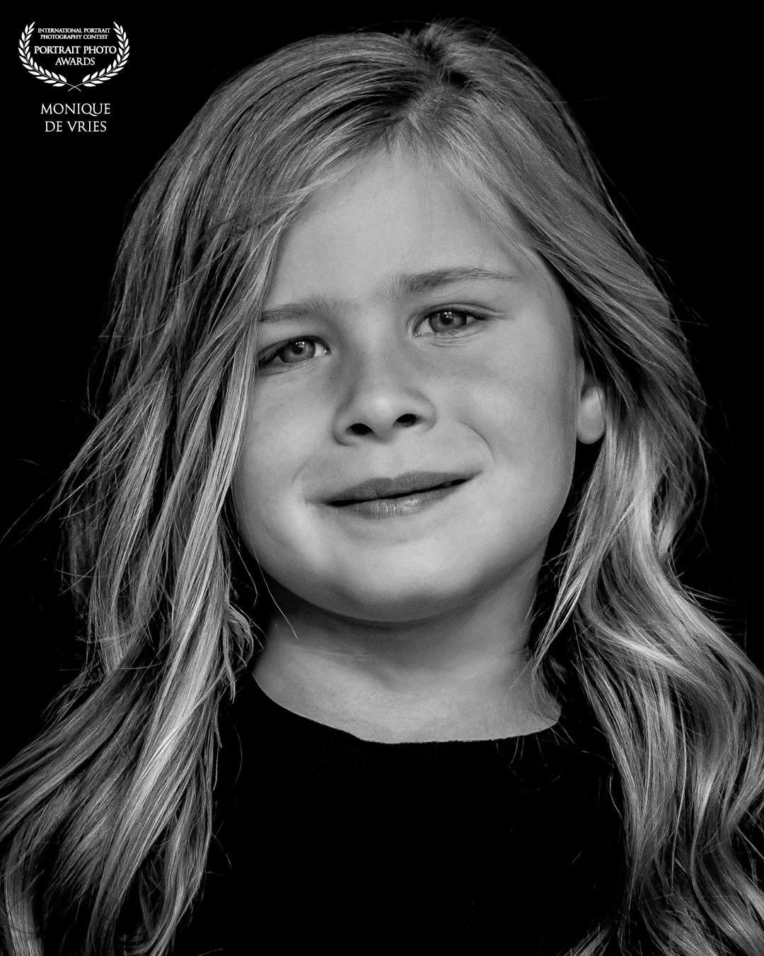 "Youth in Still Light" (girl with long hair)<br />
This portrait reflects the subtle strength and self-awareness of early youth. Her expression holds both playfulness and introspection. I chose a soft, directional light to gently sculpt her features and let her presence speak for itself—free from artifice, rooted in authenticity.