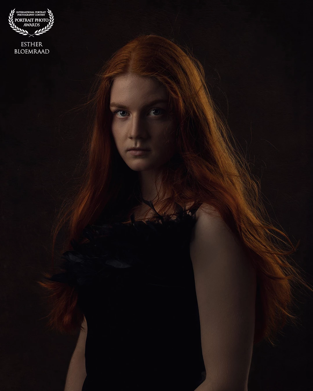 With Rembrandt lighting and a subtle rim light, her beautiful hair catches the light beautifully. The movement in her hair adds a vivid, almost cinematic feel to the portrait.<br />
<br />
Model: Jacoliene<br />
Photo & edit: @estherbloemraad.fotografie
