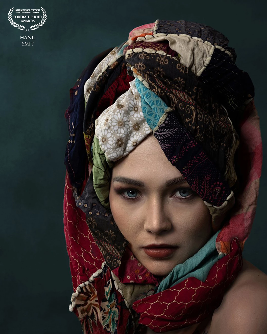 Turquoise blue eyes, let’s focus on her stunning eyes. The bright colours and the flecks of turquoise in the scarf just draws you into the piercing stare of this gorgeous model.