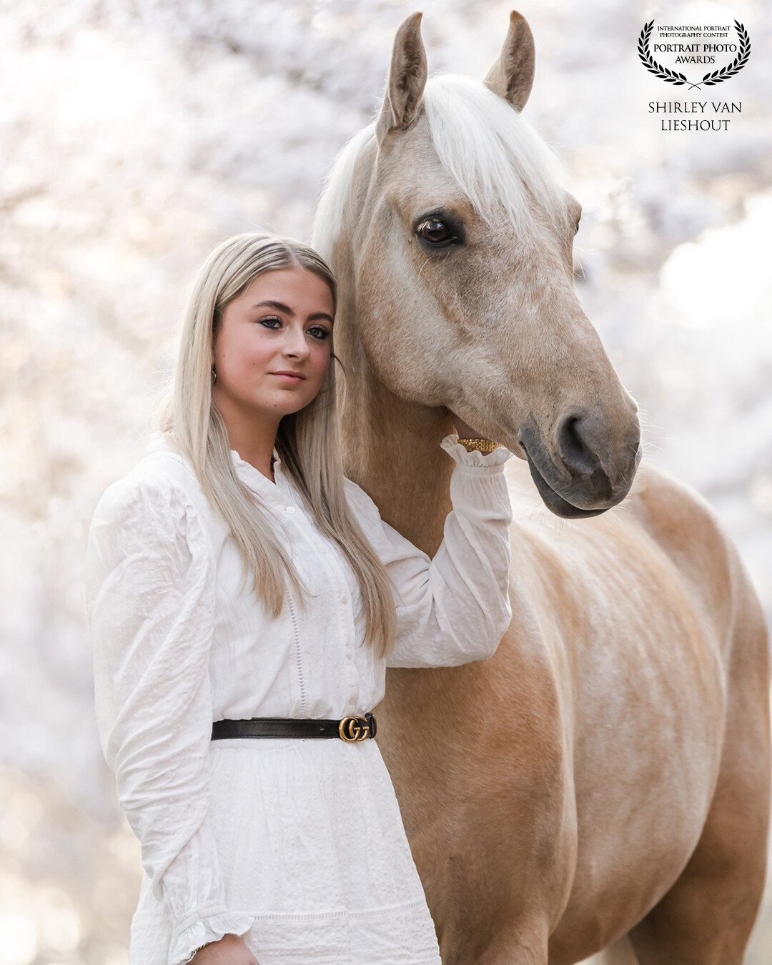 Romee with her lovely Palomino horse Royal posing in front of the beautiful blossoming trees.