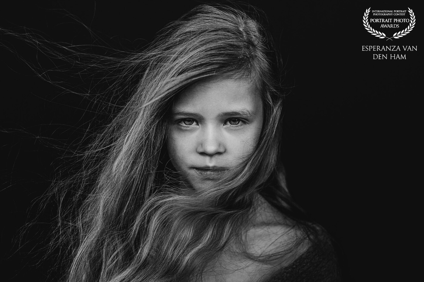 Model: Roos<br />
Created by: @iamshootingportraits<br />
www.iamshootingportraits.nl<br />
<br />
This photo is already my favorite image of the year, thanks to the perfect combination of contrast, the girl, the fluttering strands of hair, and her skin tone. Everything seems to blend perfectly, and this photo exudes an extraordinary aura. All rights reserved.
