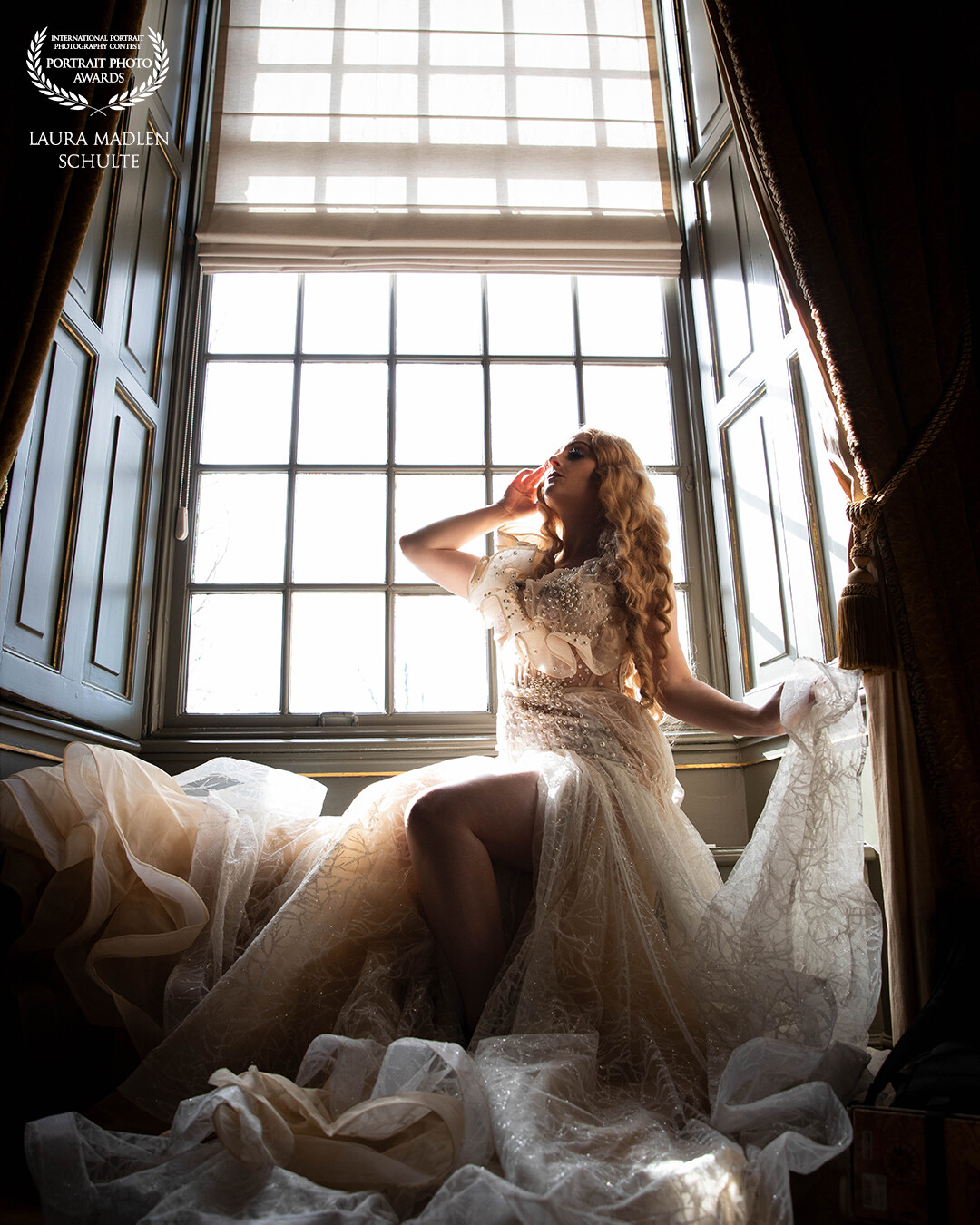 "A dance in an old castle. The last rays of sunlight illuminate the hall through the large windows. Tired feet from dancing let you take a break and enjoy the light."<br />
This picture was taken during a photo shoot in a castle in the Netherlands with available light & the Canon EOS 5D Mark IV + 24-70 2.8<br />
The model is Maya Lou and the outfit is made by Oksana Schleekeil Design.