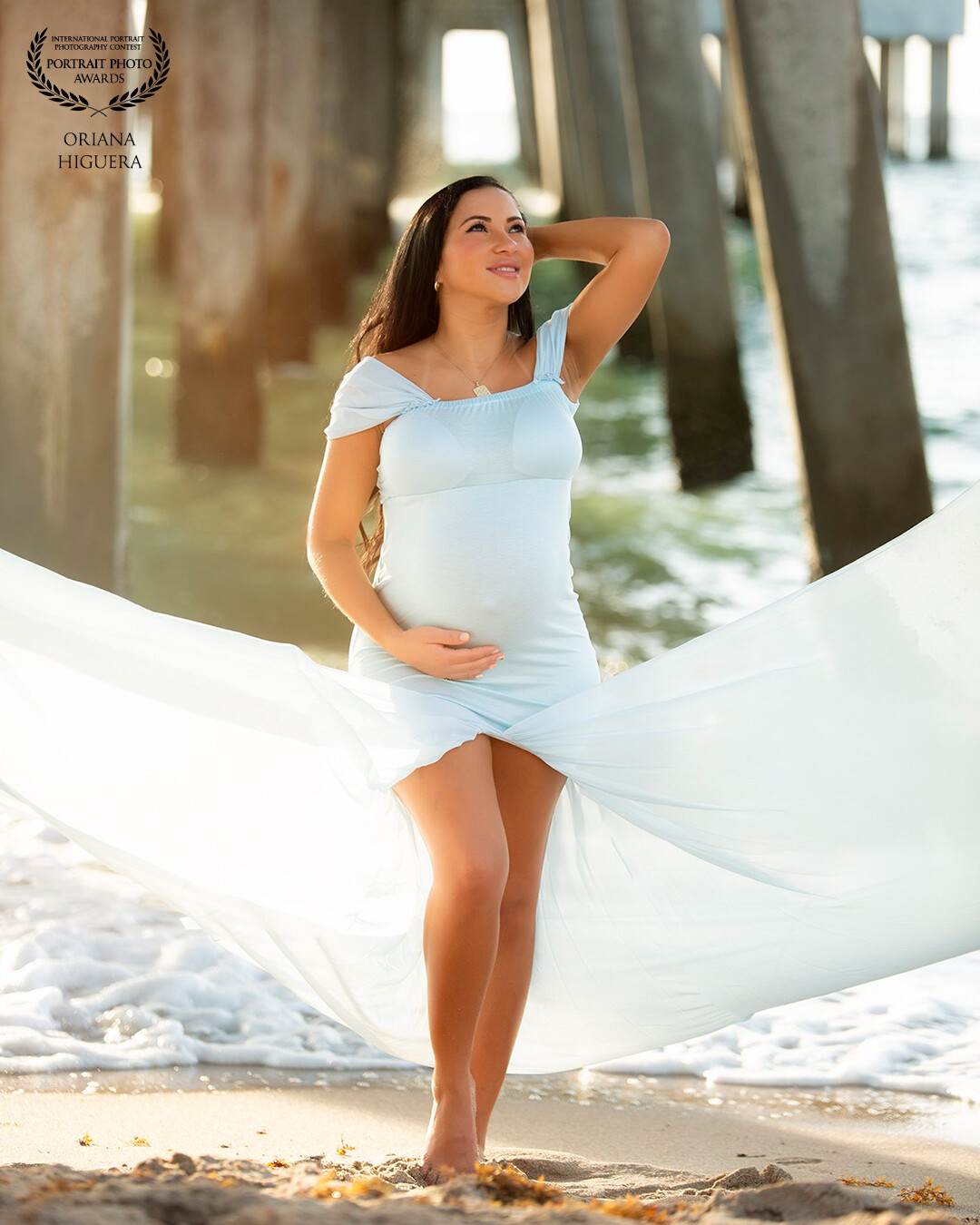 It's Paola first baby, and she wanted to celebrate her maternity with photos, we went to the beach at sunrise and God gave us the most beautiful Sunlight that we could ask for. This image was made with natural light  under the pier.