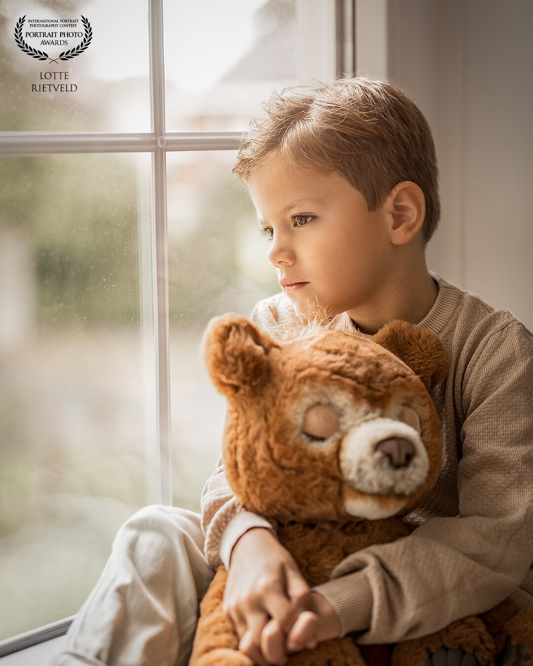 "A Little Dreamer" captures the wonder of youth, as seen in the dreamy gaze of the boy. The soft daylight lends a beautiful atmosphere to the photo.